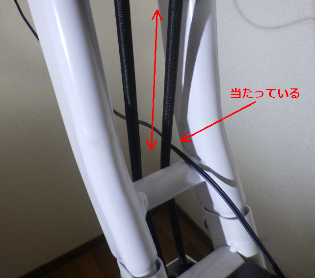 上下矢印の方向に動くゴム紐が、メーターに繋がるケーブルに当たる
